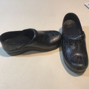 Black patterned clogs.